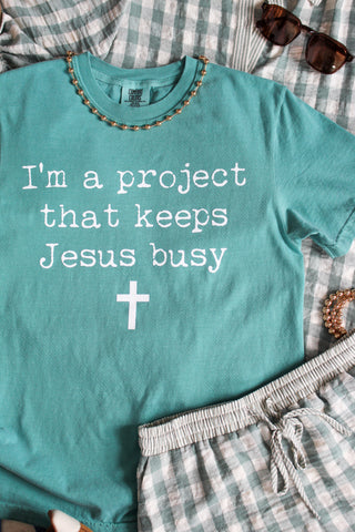 I’m A Project That Keeps Jesus Busy Graphic Tee • Seafoam